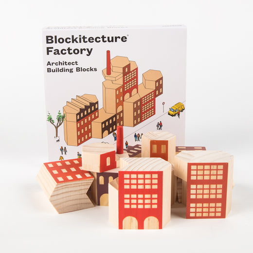 Blocs de bois devant une boîte sur laquelle on peut lire, en anglais, « Blockitecture® Factory Architect Building Blocks »