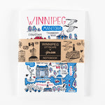 carnet entouré d’une bande de papier brun sur lequel on peut lire « Winnipeg Cityscape by Julian Gash Notebook »